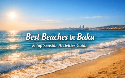 A picturesque view of the coastline in Baku, highlighting the best beaches and seaside activities, with sunlight reflecting on the water and a city skyline in the background.